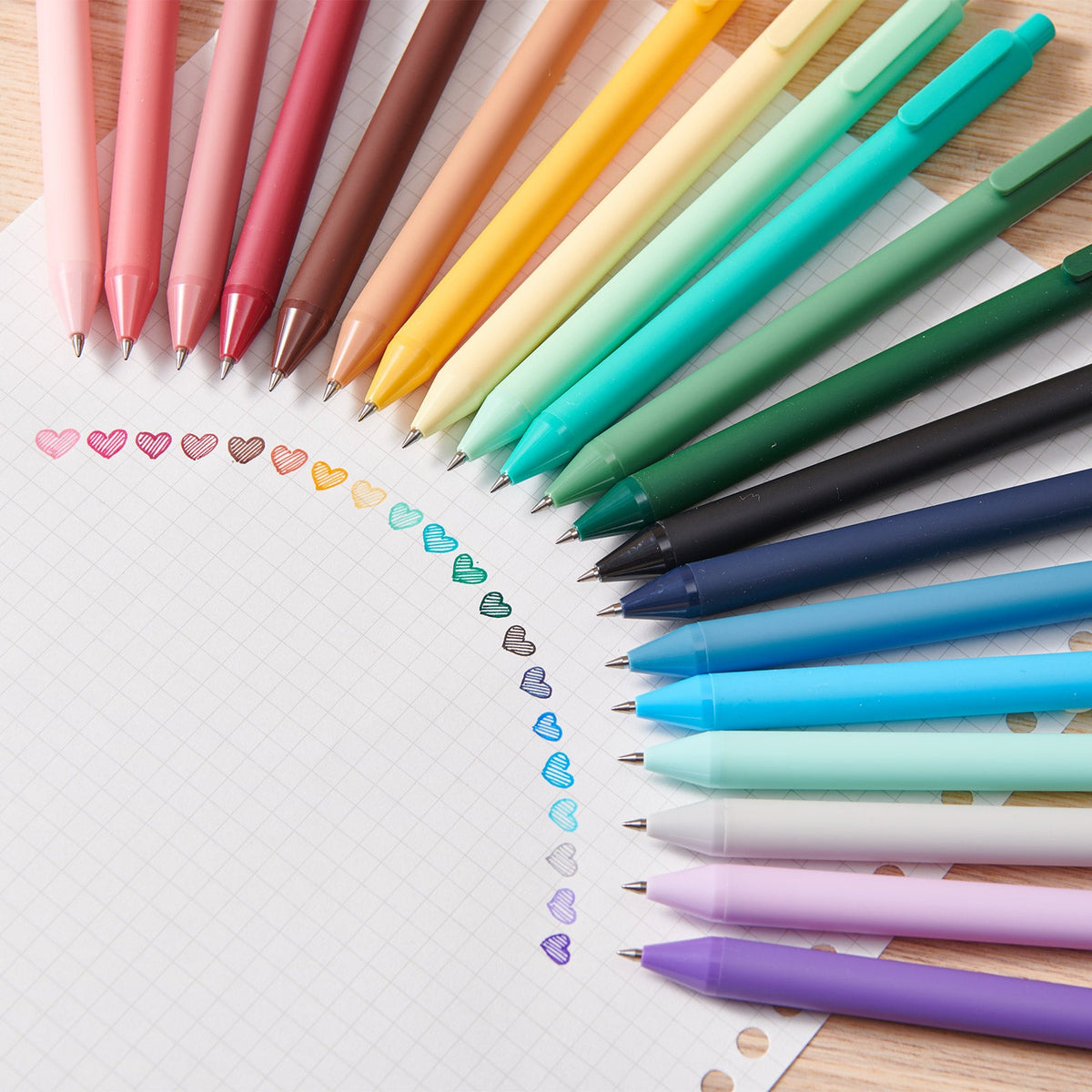 A fan of KACO PURE coloured gel pens above hand-drawn hearts