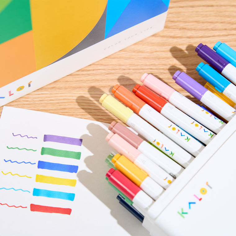 Kalor markers in a white case with the colourful box behind and marker swatches on paper